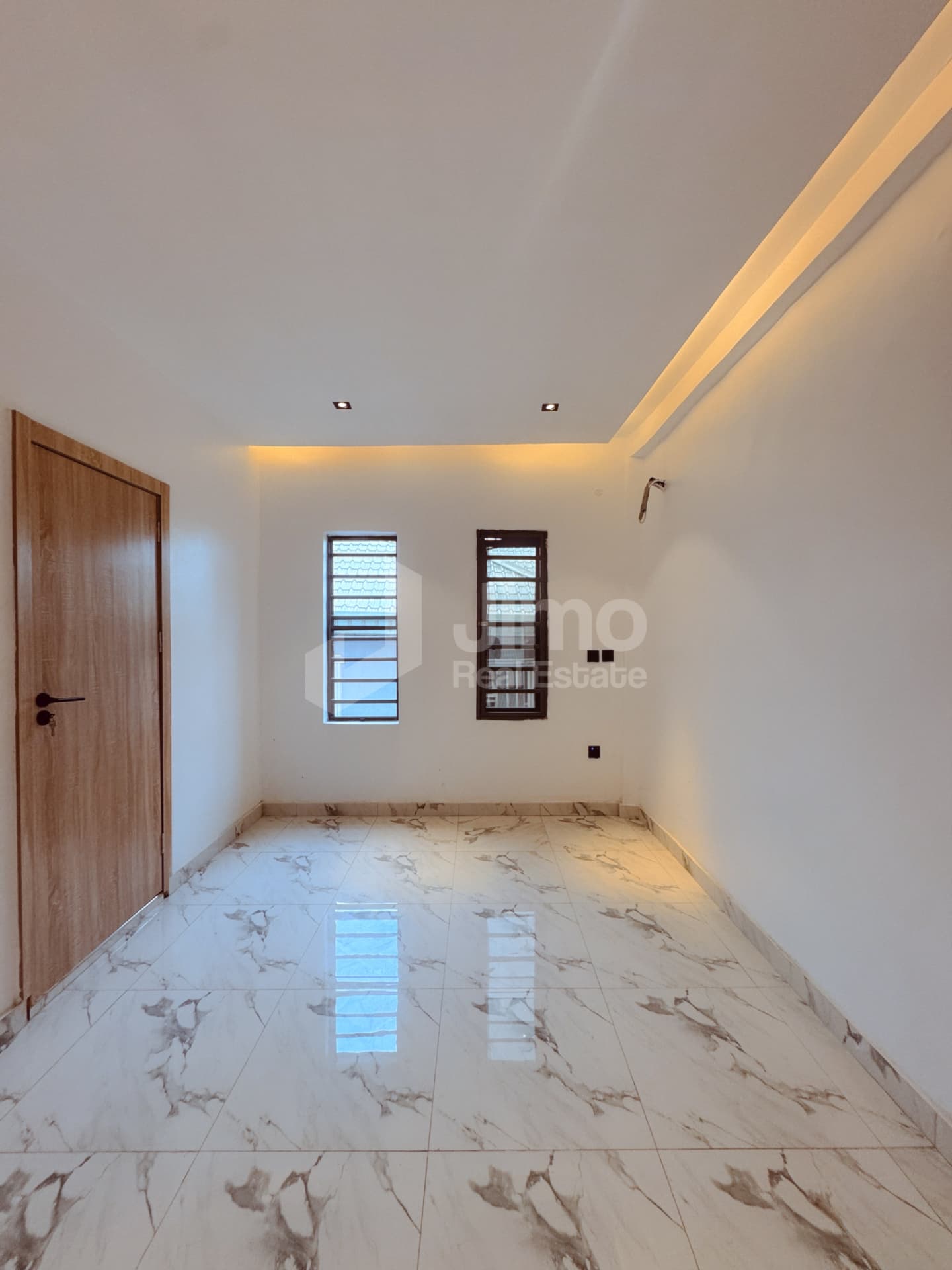 Bright bedroom with marble-look floor tiles
