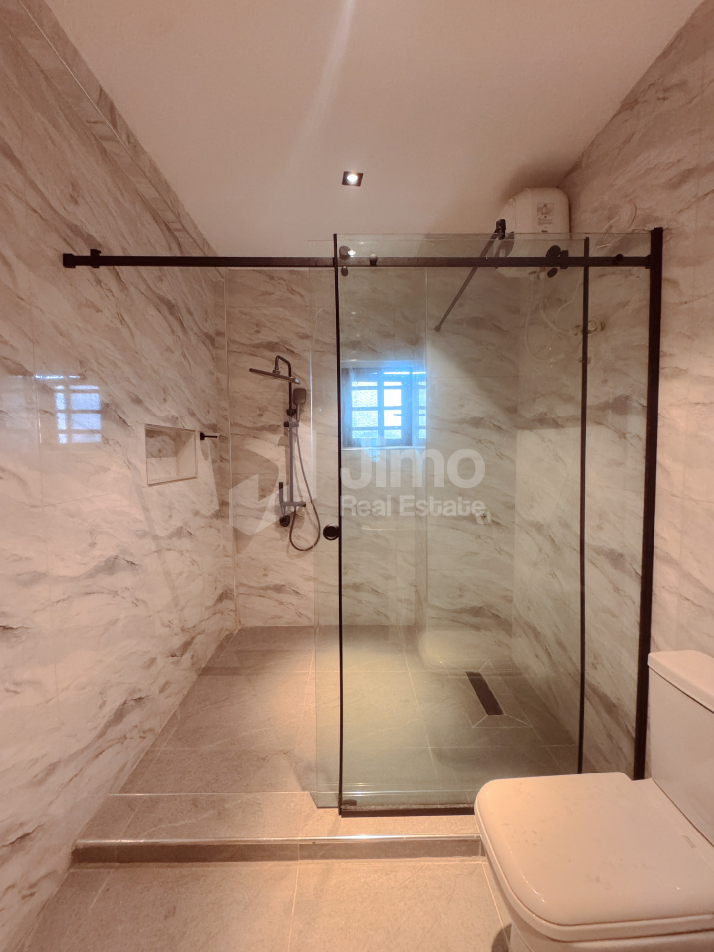 En-suite bathroom with glass shower and water heater